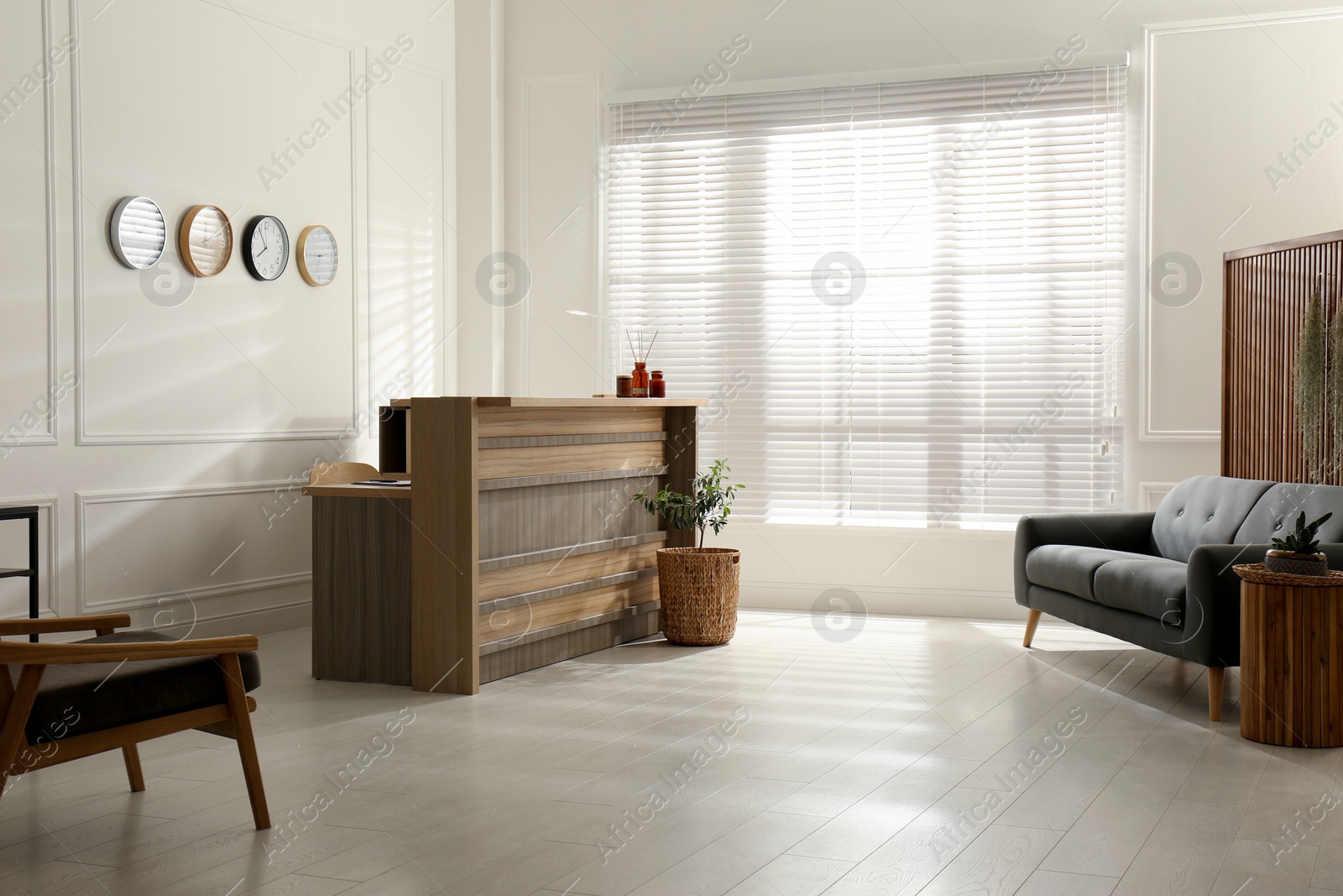 Photo of Hotel lobby interior with wooden reception desk. Stylish workplace