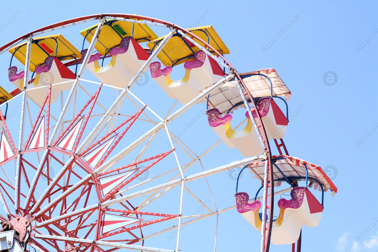 Photo of Large empty observation wheel against blue sky