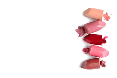 Photo of Different lipstick swatches on white background, top view