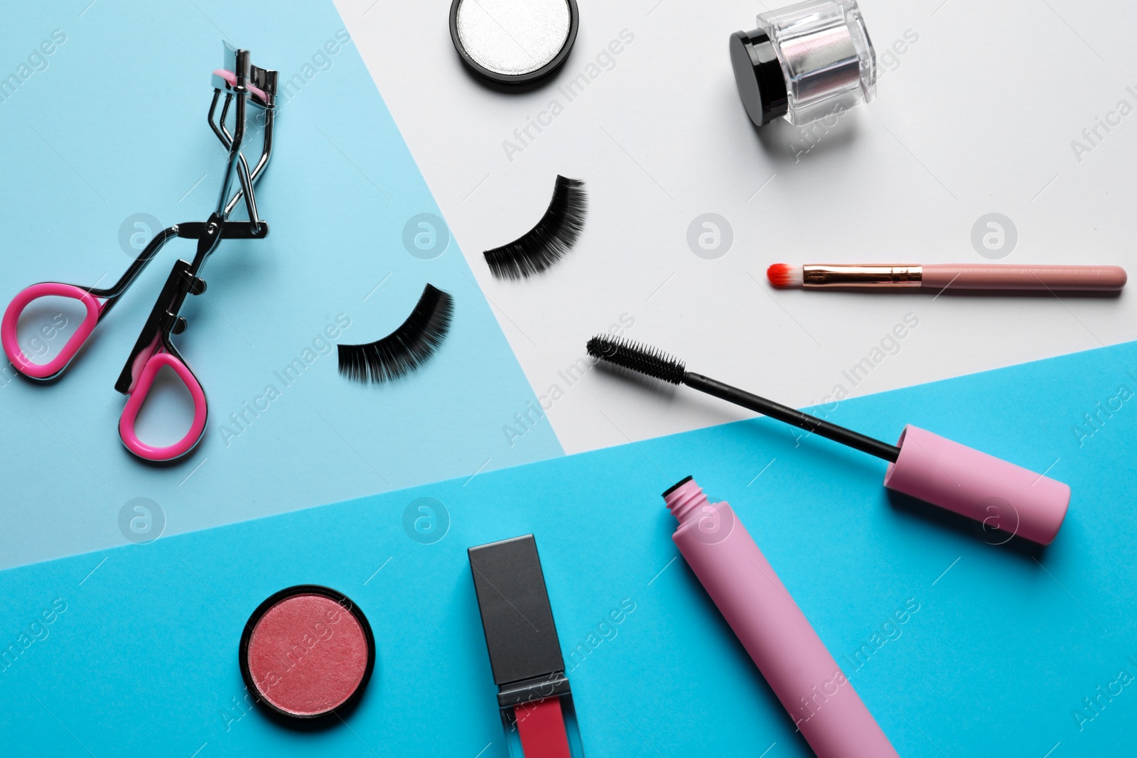 Photo of Flat lay composition with false eyelashes and other makeup products on color background