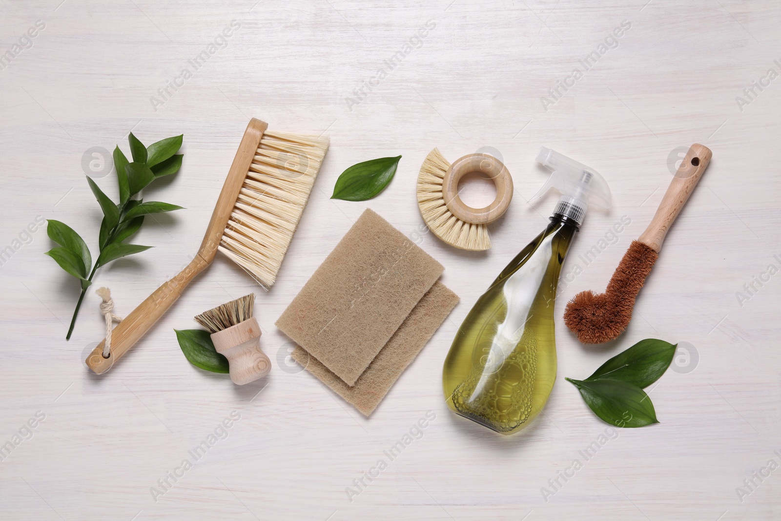 Photo of Flat lay composition with different cleaning supplies on light wooden background