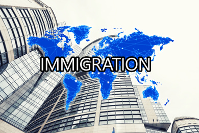 Image of Word IMMIGRATION with world map and low angle view of modern buildings on background