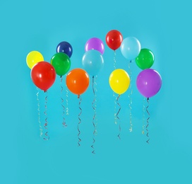 Bright balloons on color background. Celebration time