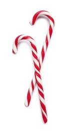 Sweet candy canes on white background, top view. Christmas treat 