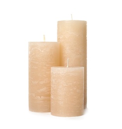 Three color wax candles on white background