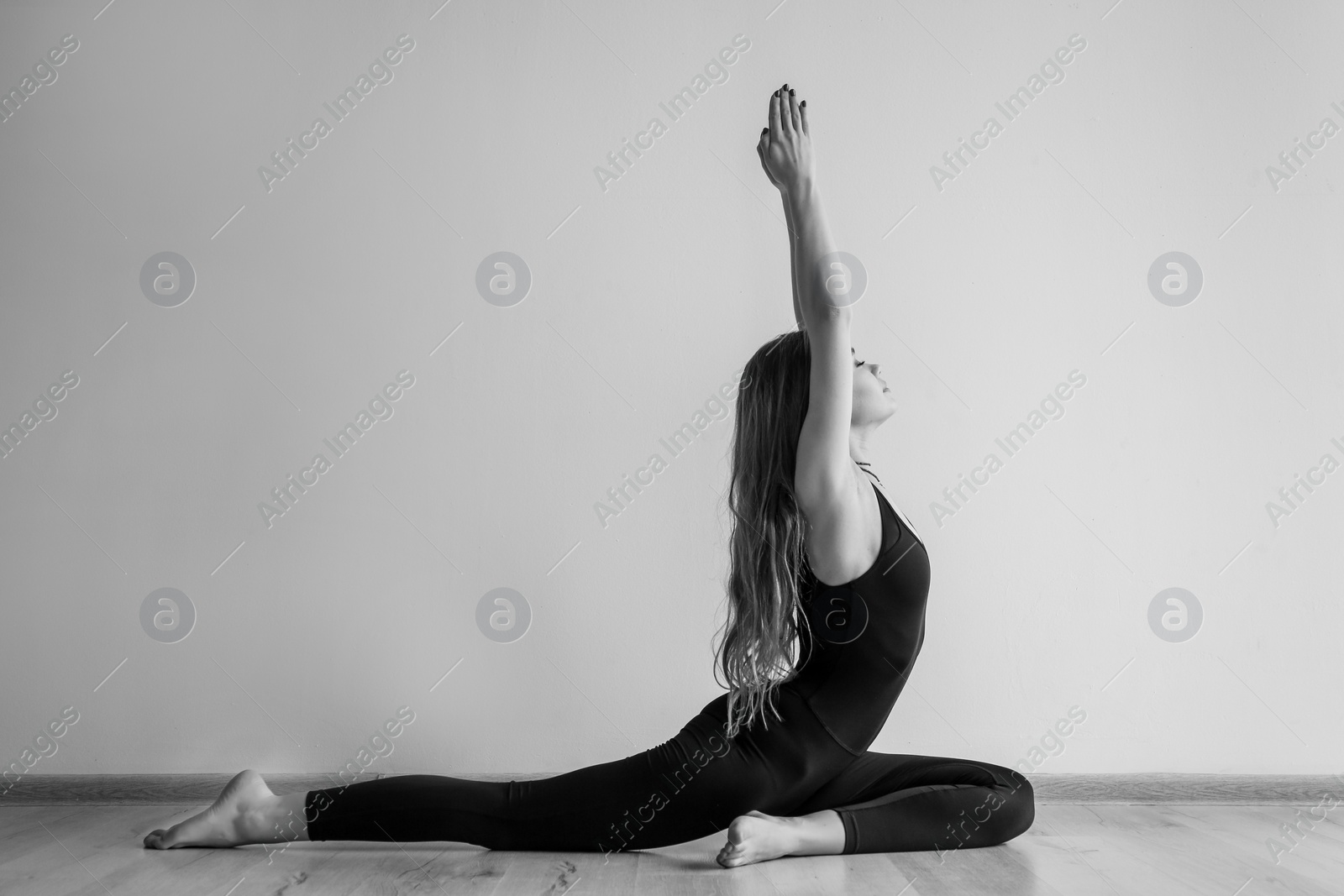 Photo of Young woman practicing yoga indoors