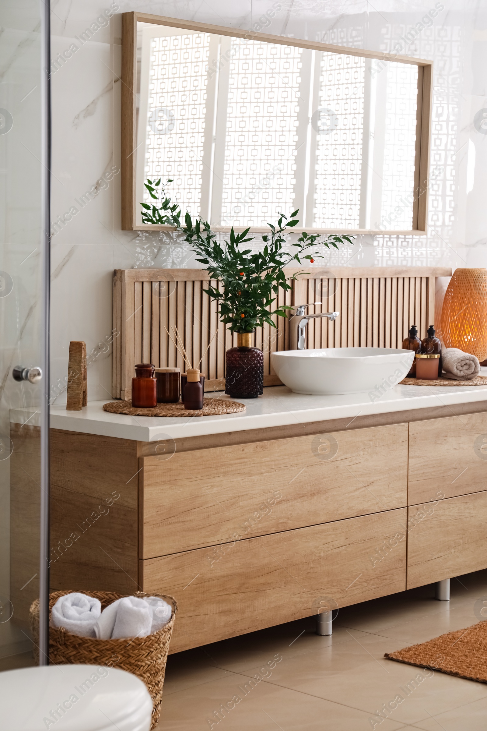 Photo of Modern bathroom interior with stylish mirror and vessel sink