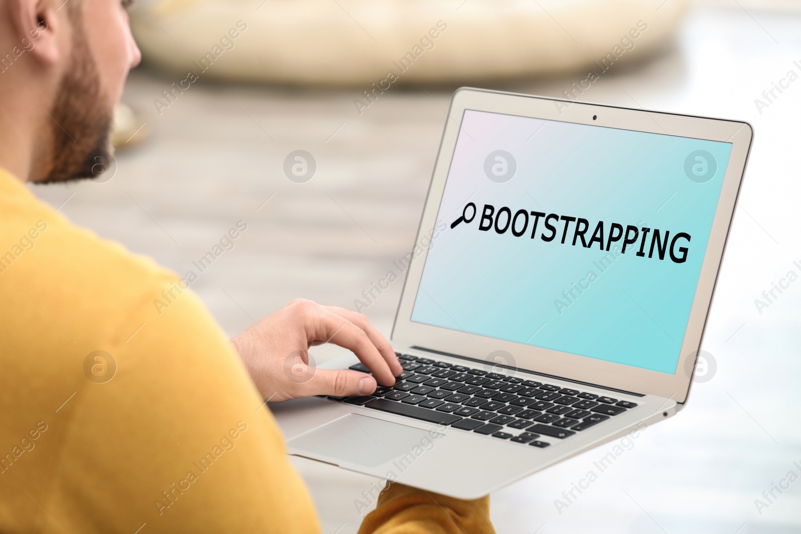 Image of Young man using laptop at home, closeup. Bootstrap button