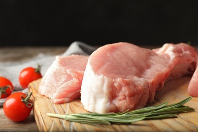 Photo of Fresh raw cut meat on wooden board, closeup