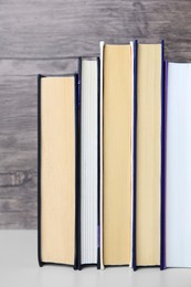 Photo of Collection of different books on white shelf