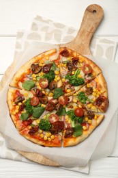 Delicious vegetarian pizza with mushrooms, vegetables and parsley on white wooden table, top view