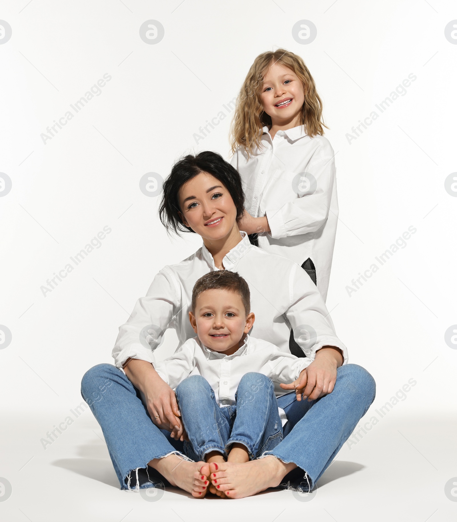 Photo of Little children with their mother on white background