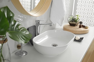Photo of Vessel sink and decor elements in modern bathroom interior