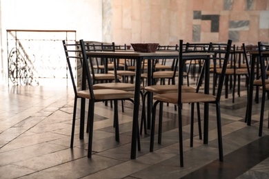 Photo of Simple cafeteria interior with set of stylish furniture