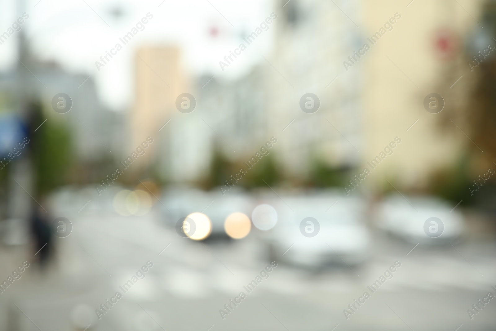 Photo of Blurred view of quiet city with buildings and cars on road