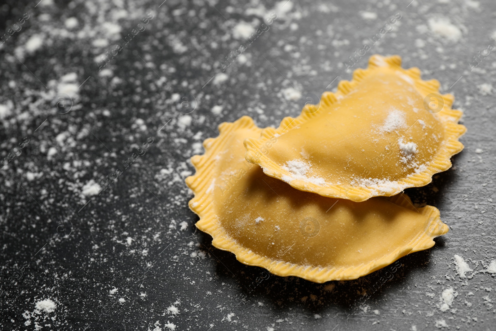 Photo of Ravioli on grey wooden table, closeup. Italian pasta