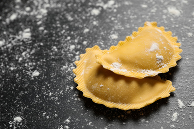 Photo of Ravioli on grey wooden table, closeup. Italian pasta