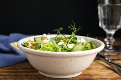 Delicious salad with lentils, vegetables and feta cheese served on wooden table