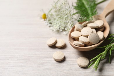 Photo of Pills and herbs on wooden table, closeup with space for text. Dietary supplements