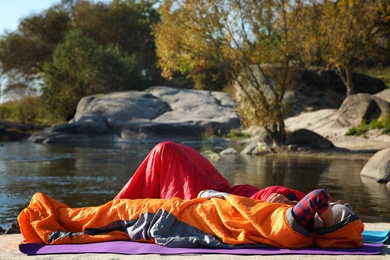 Campers in sleeping bags outdoors. Professional equipment