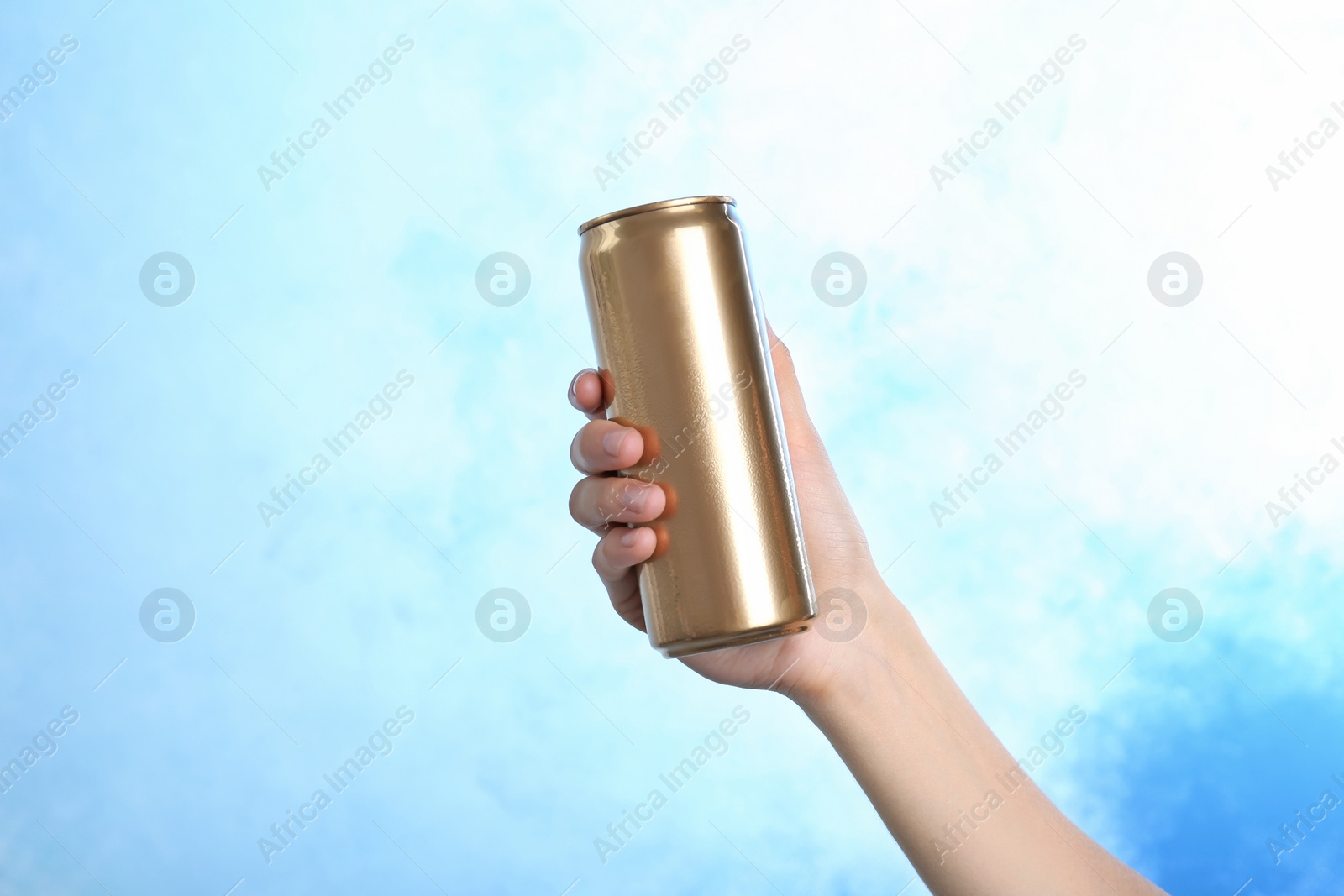 Photo of Woman holding aluminum can with beverage on color background