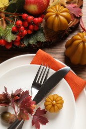 Photo of Festive table setting with autumn decor on wooden background, flat lay