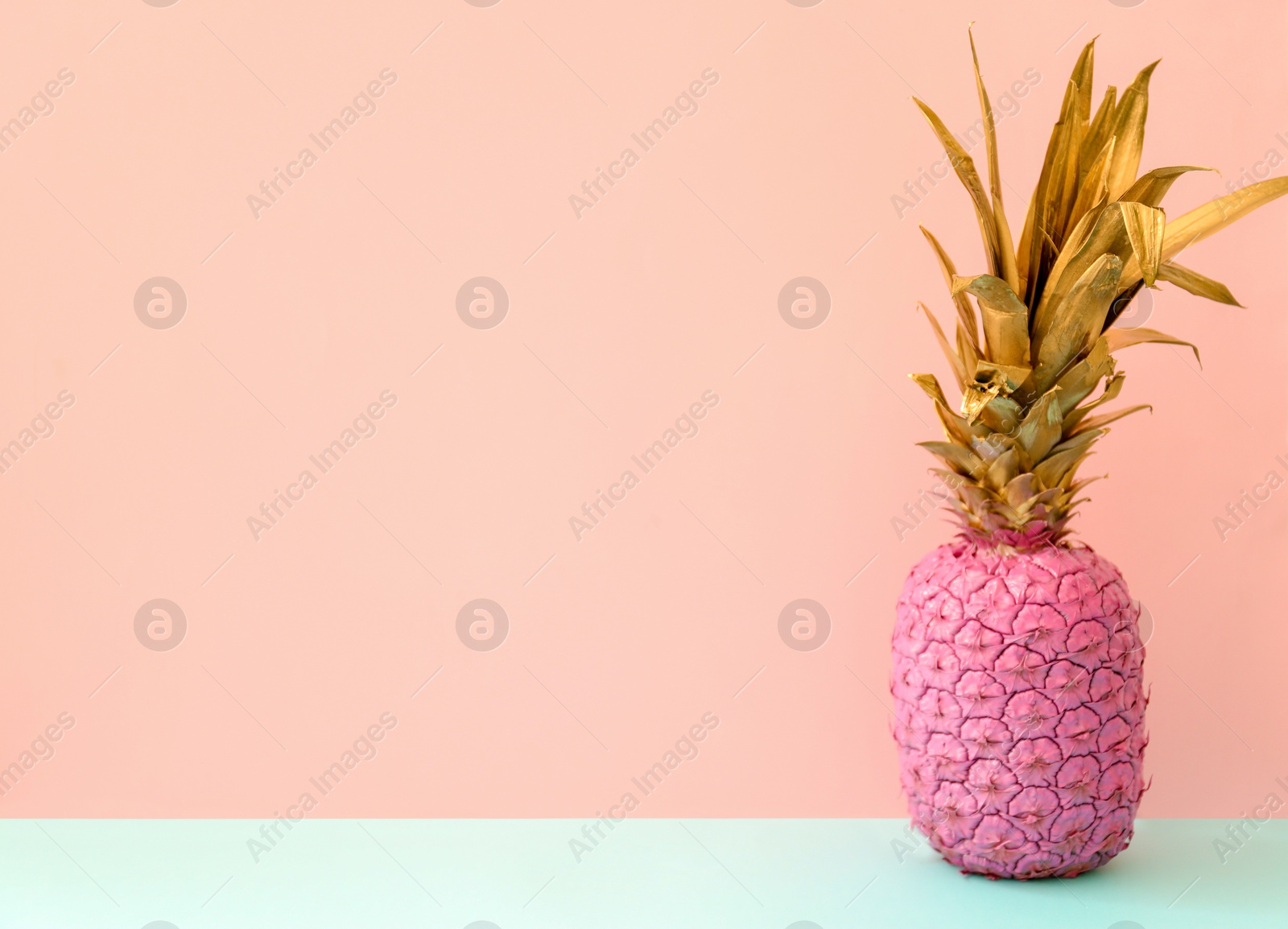 Photo of Pink pineapple on color background