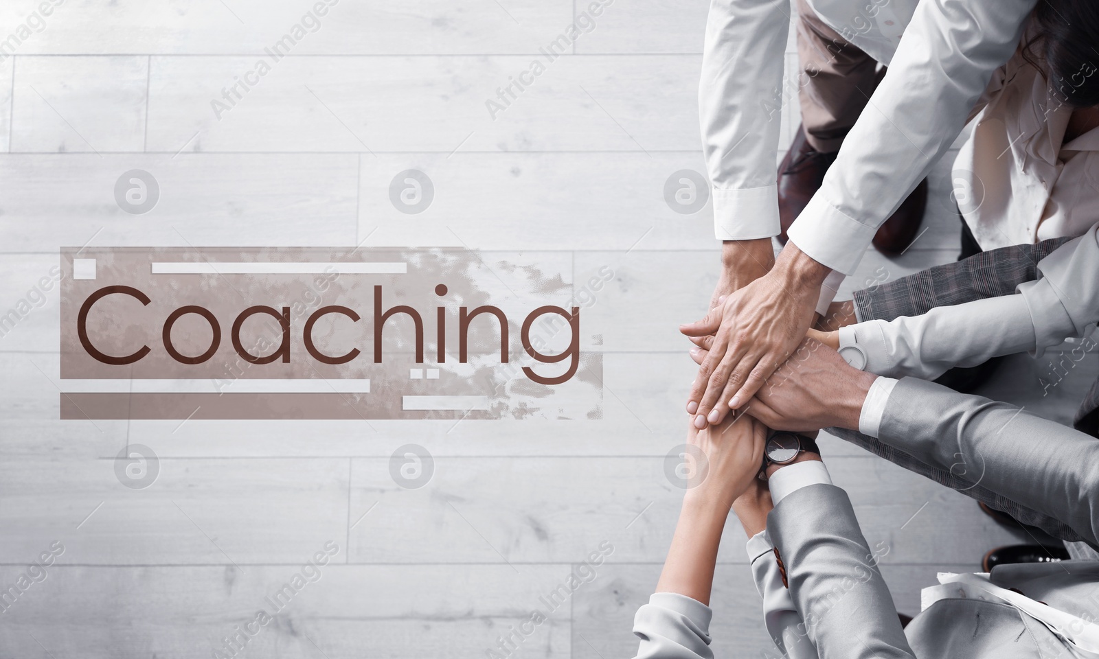 Image of Adult learning. Word Coaching and people holding hands together over light wooden background, top view