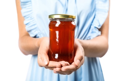 Woman holding jar with delicious honey on white background