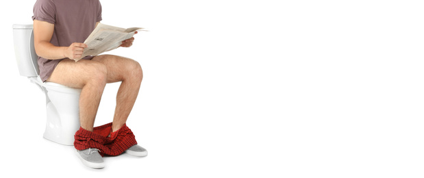 Image of Closeup view of man reading newspaper while sitting on toilet bowl against white background. Banner design