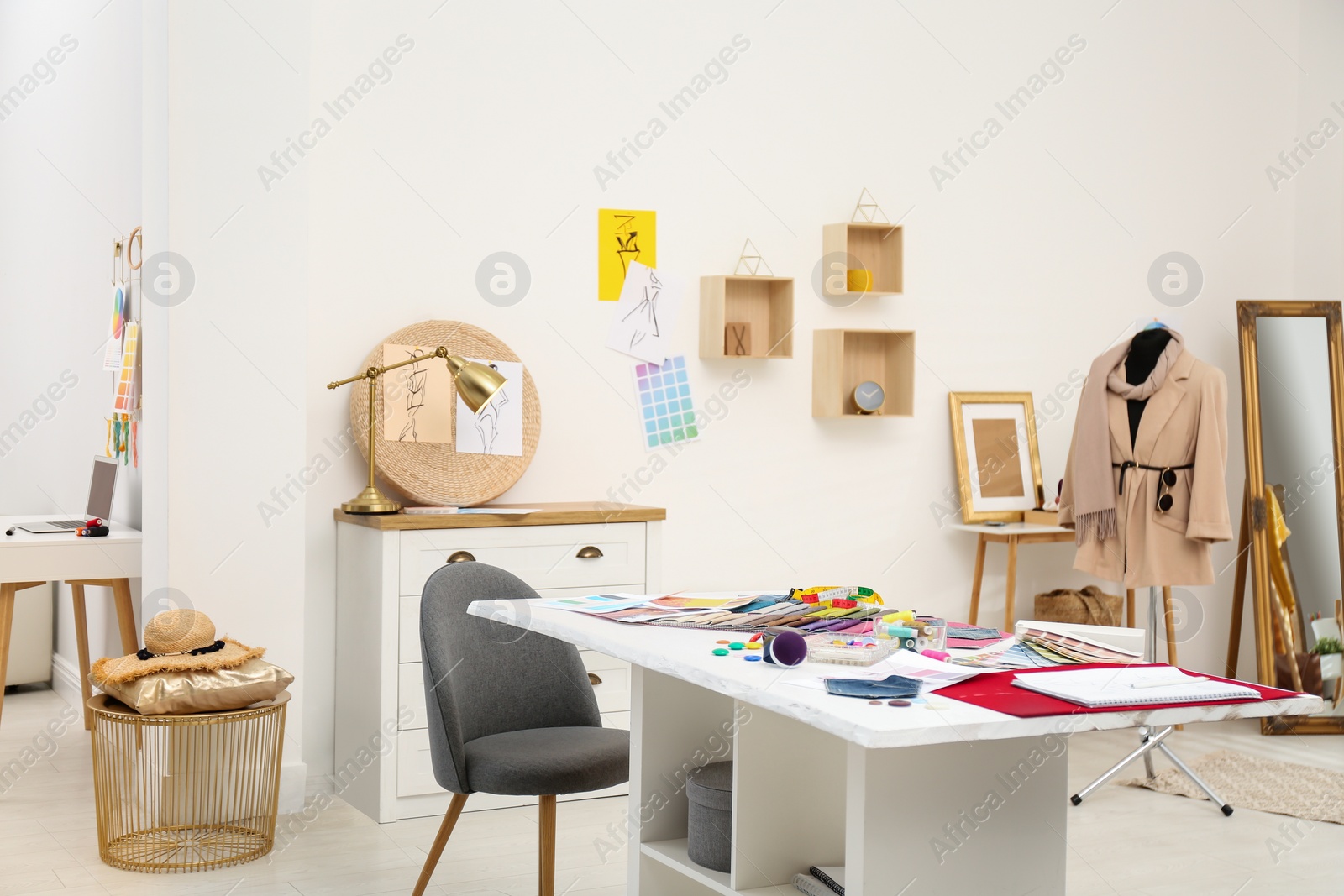 Photo of Fashion designer's workplace in studio. Creating new clothes