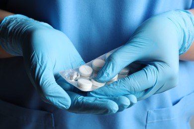 Photo of Doctor taking pill out from blister pack, closeup