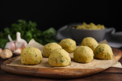 Raw falafel balls on wooden table. Space for text