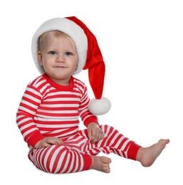 Cute baby in Santa hat and Christmas pajamas sitting on white background