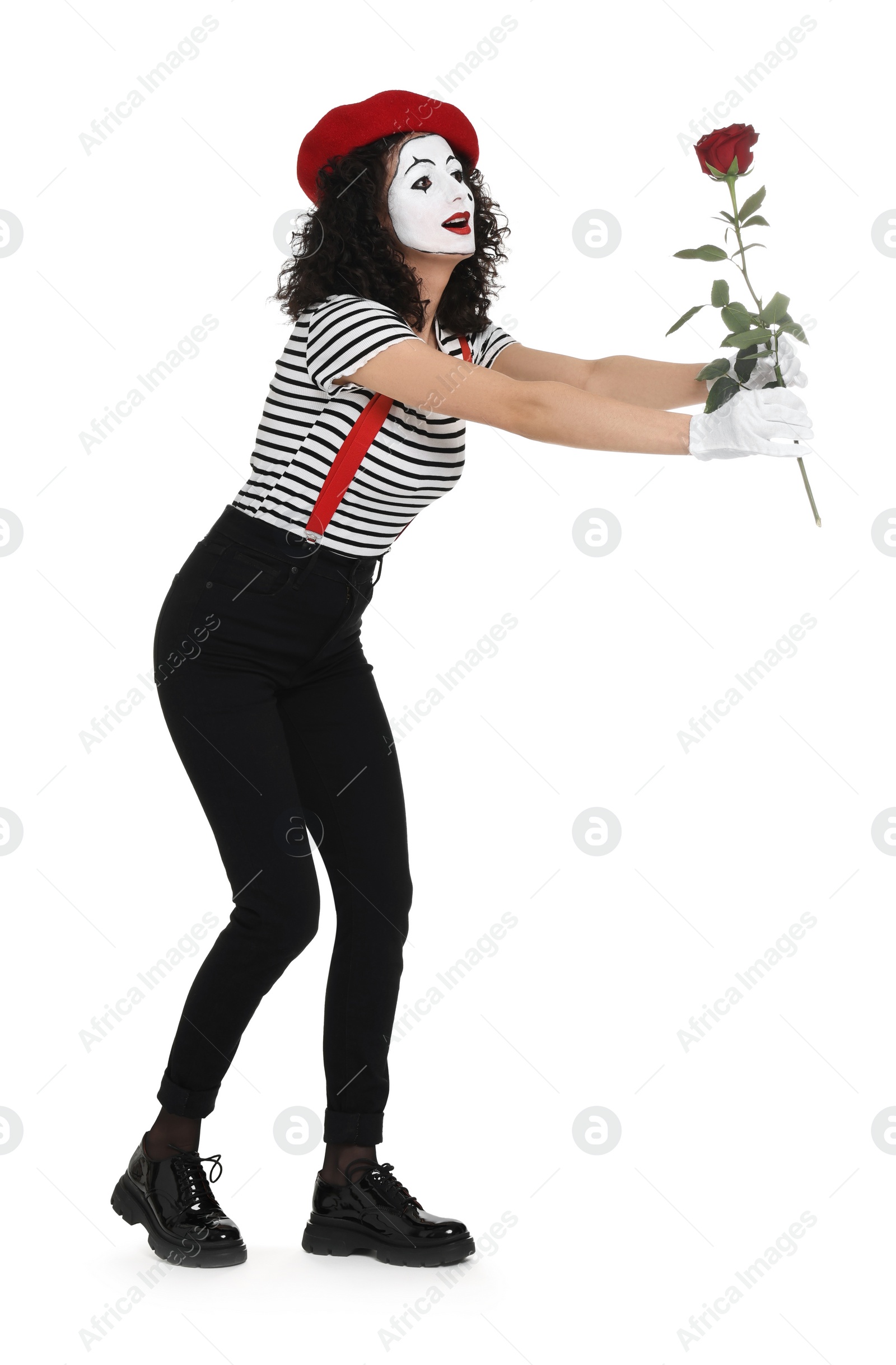 Photo of Funny mime with red rose posing on white background