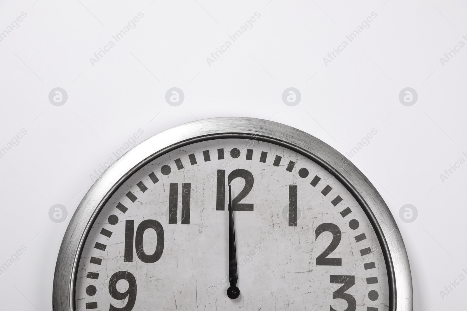 Photo of Stylish analog clock hanging on white wall, space for text