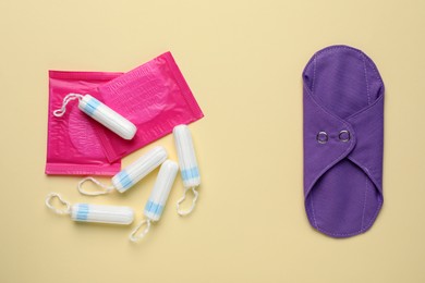 Photo of Different menstrual hygiene products on beige background, flat lay