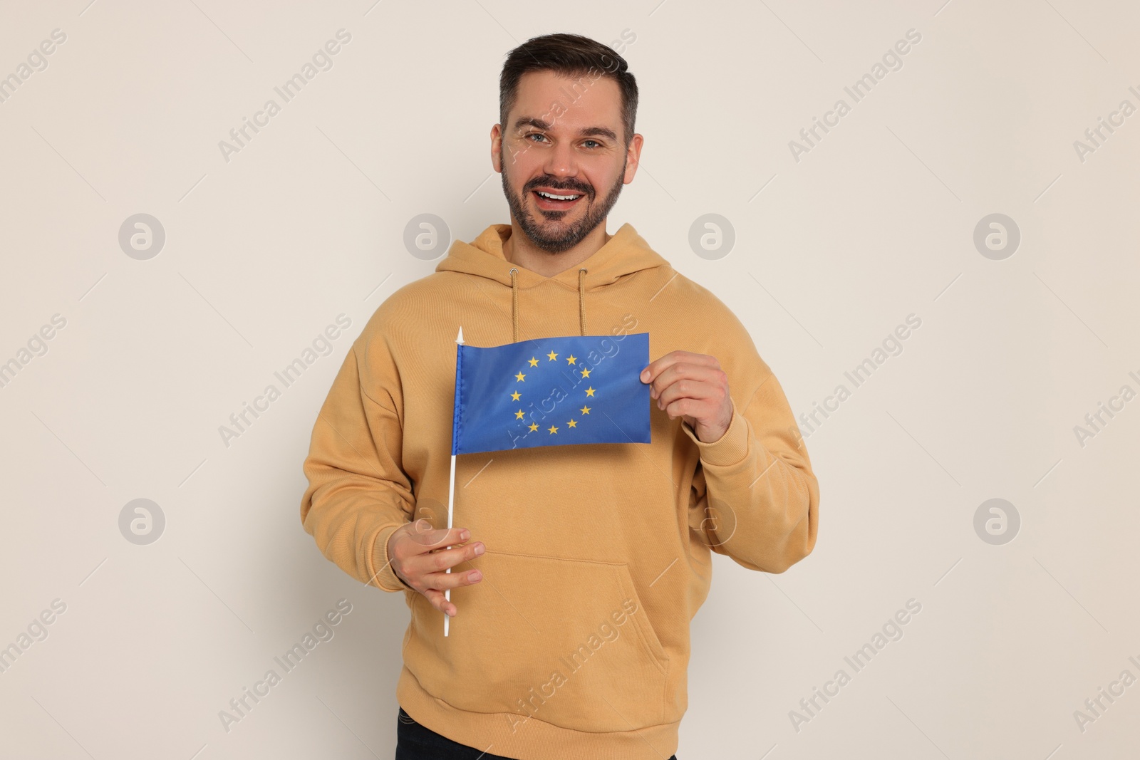 Photo of Man with flag of European Union on white background