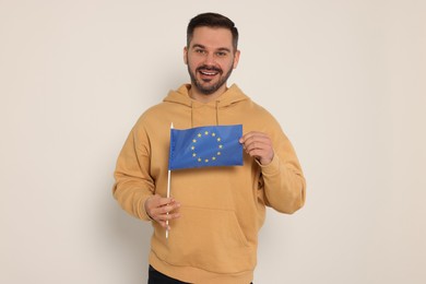 Man with flag of European Union on white background