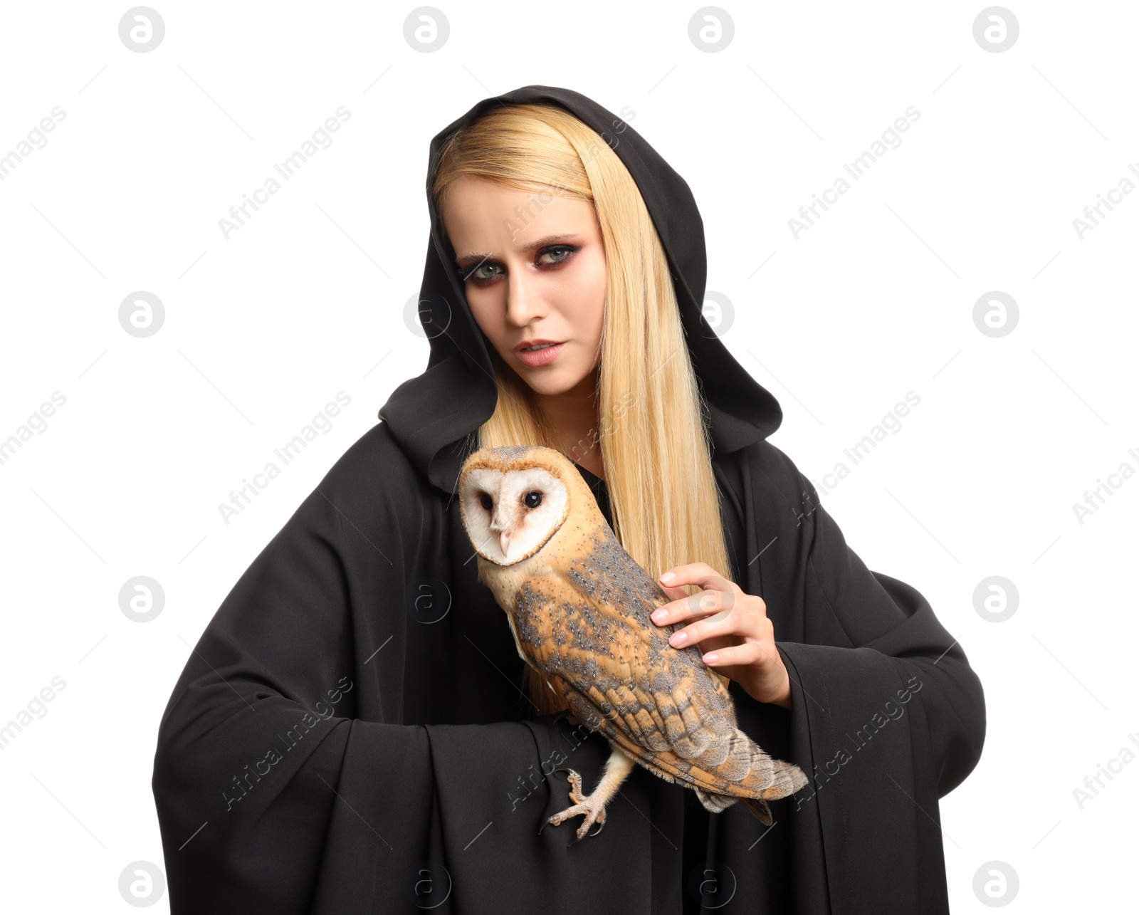 Photo of Witch in black mantle with owl isolated on white. Scary fantasy character