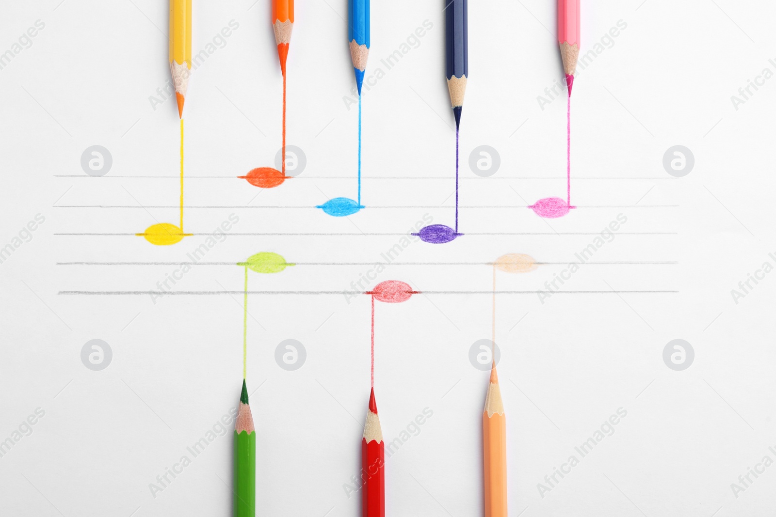 Photo of Drawing of musical notes and colorful pencils on white background, top view