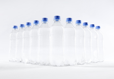 Plastic bottles with pure water on white background