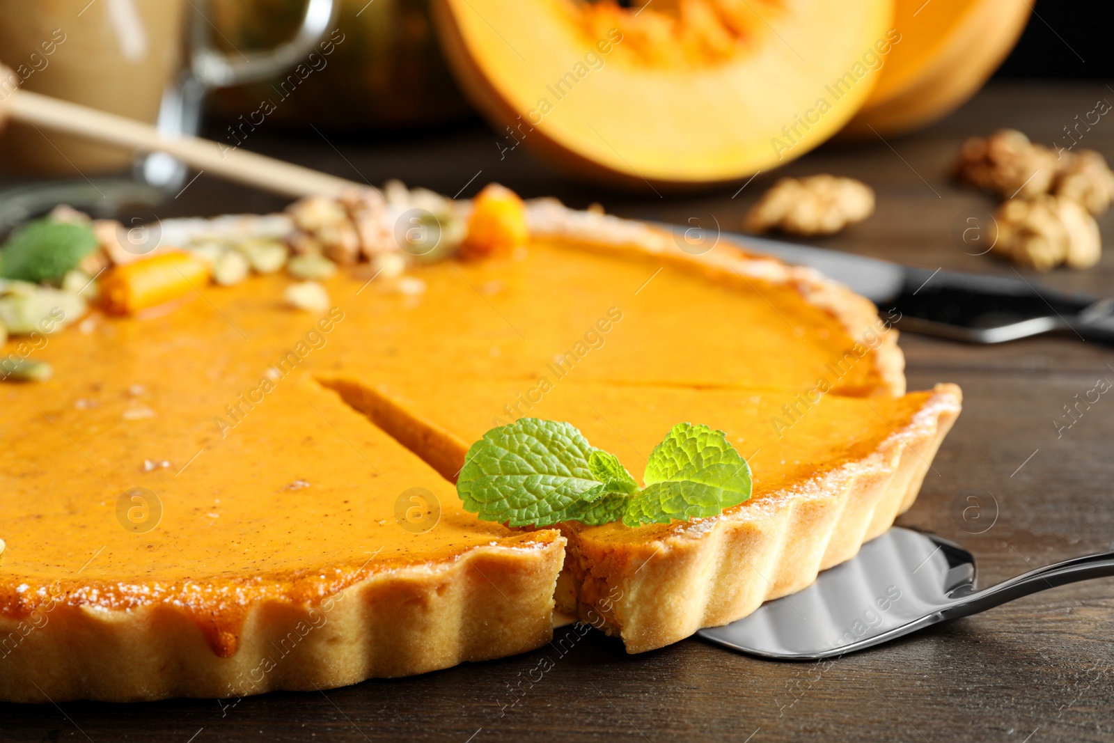 Photo of Delicious fresh homemade pumpkin pie on dark wooden table, closeup