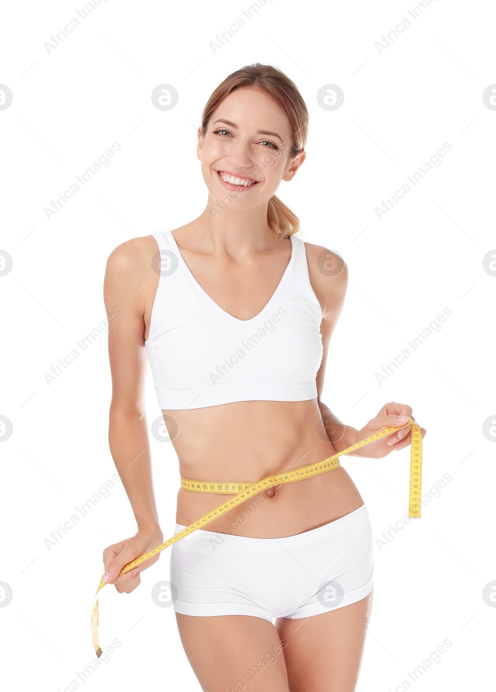 Photo of Happy slim woman in underwear with measuring tape on white background. Positive weight loss diet results