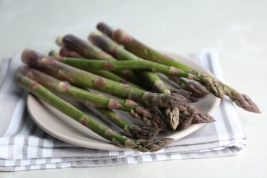 Photo of Fresh raw asparagus on table, closeup view