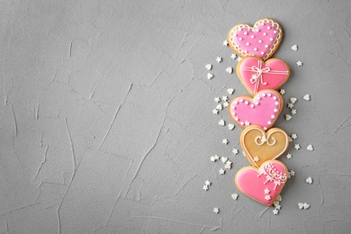 Photo of Flat lay composition with decorated heart shaped cookies and space for text on table