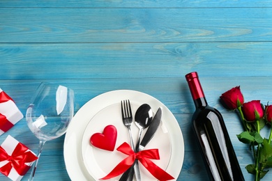 Photo of Beautiful table setting on light blue wooden background, flat lay with space for text. Valentine's Day dinner