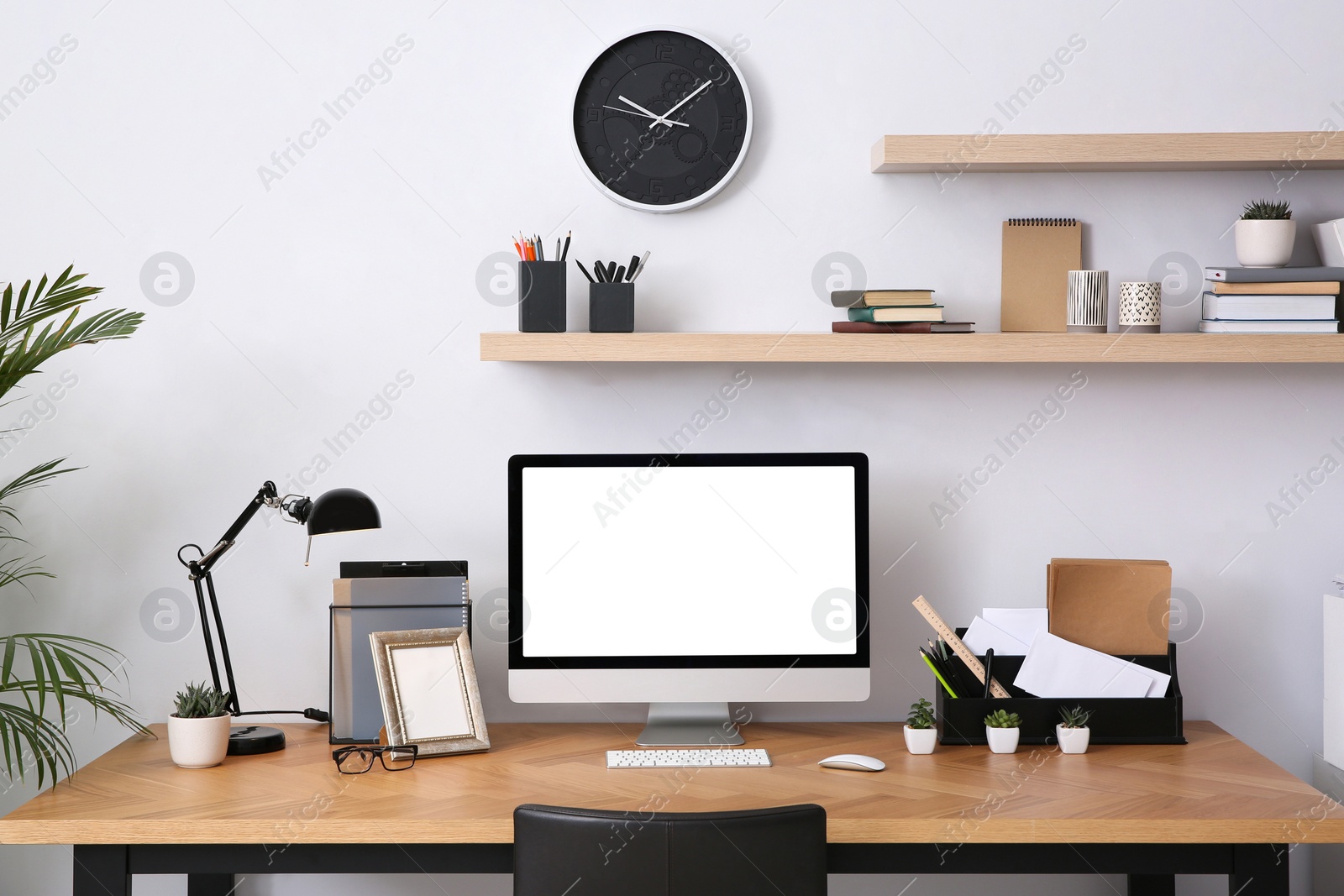 Photo of Modern computer on table in office interior. Stylish workplace