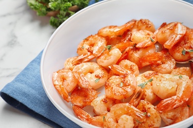 Photo of Bowl with delicious fried shrimps on table