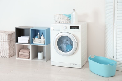 Photo of Washing of different towels in modern laundry room